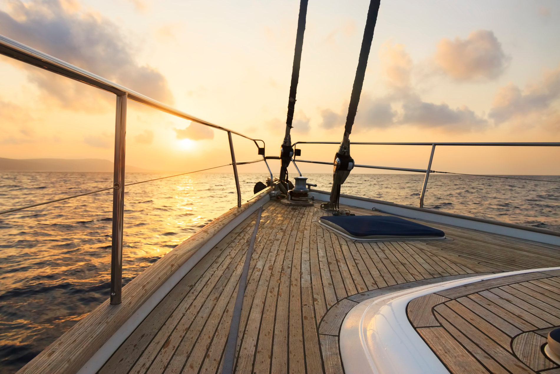 Yacht sailing at sunset